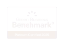 Green Business Benchmark certification logo with white text on black background.