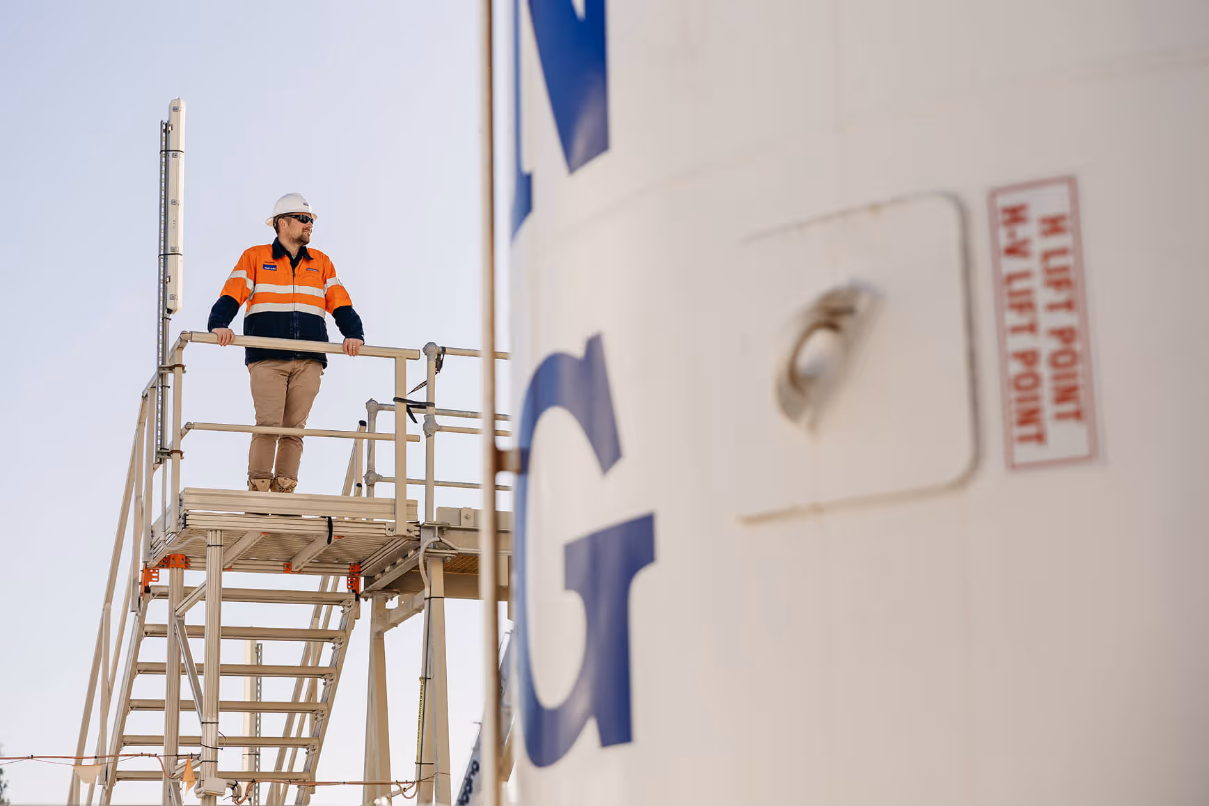 Interior of a large industrial warehouse filled with heavy machinery, equipment, and tools organized on the floor.