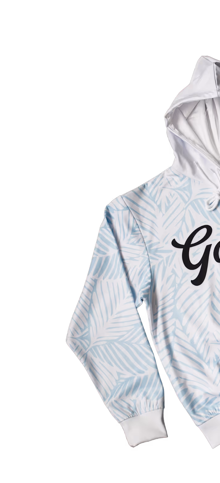 White hoodie with light blue palm leaf pattern and partial black text on the front.