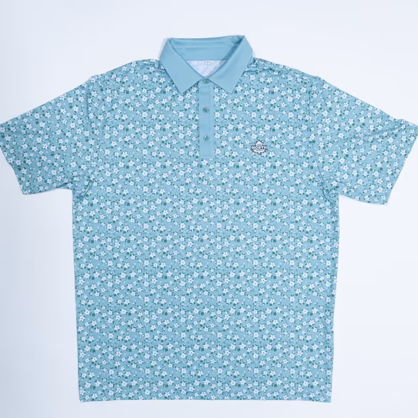 Light teal polo shirt with a small white floral pattern and solid teal collar and button placket.