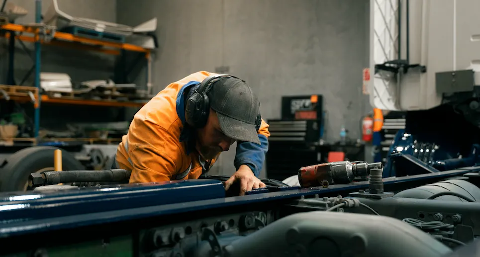 Keast Auto Repair mechanic working on a large vehicle in the workshop