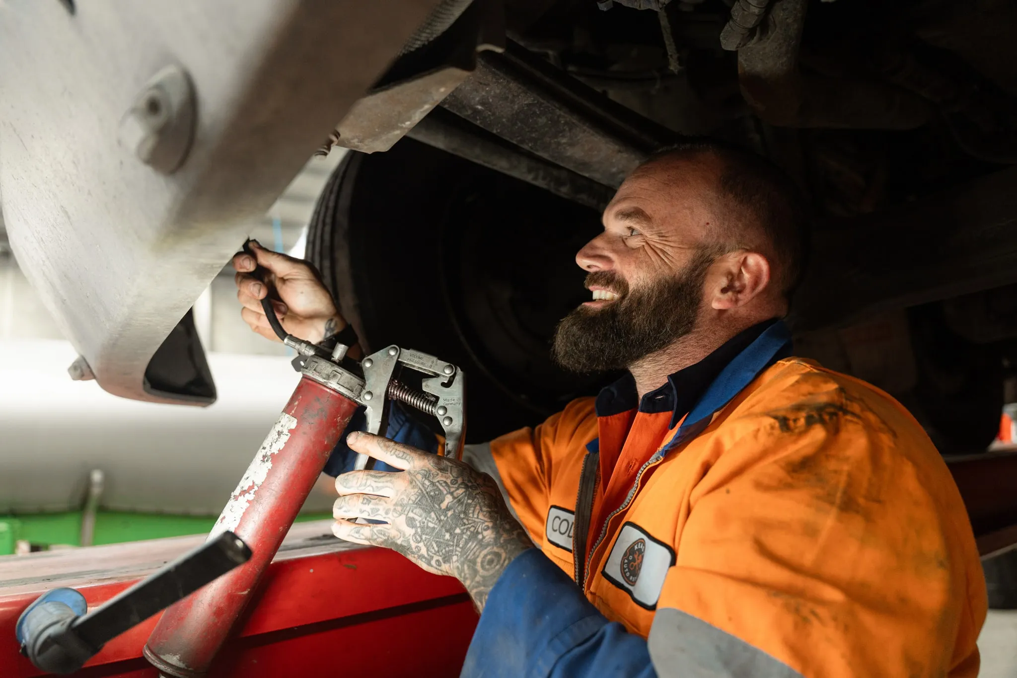 Mechanic working on hoisted car in Invercargill workshop