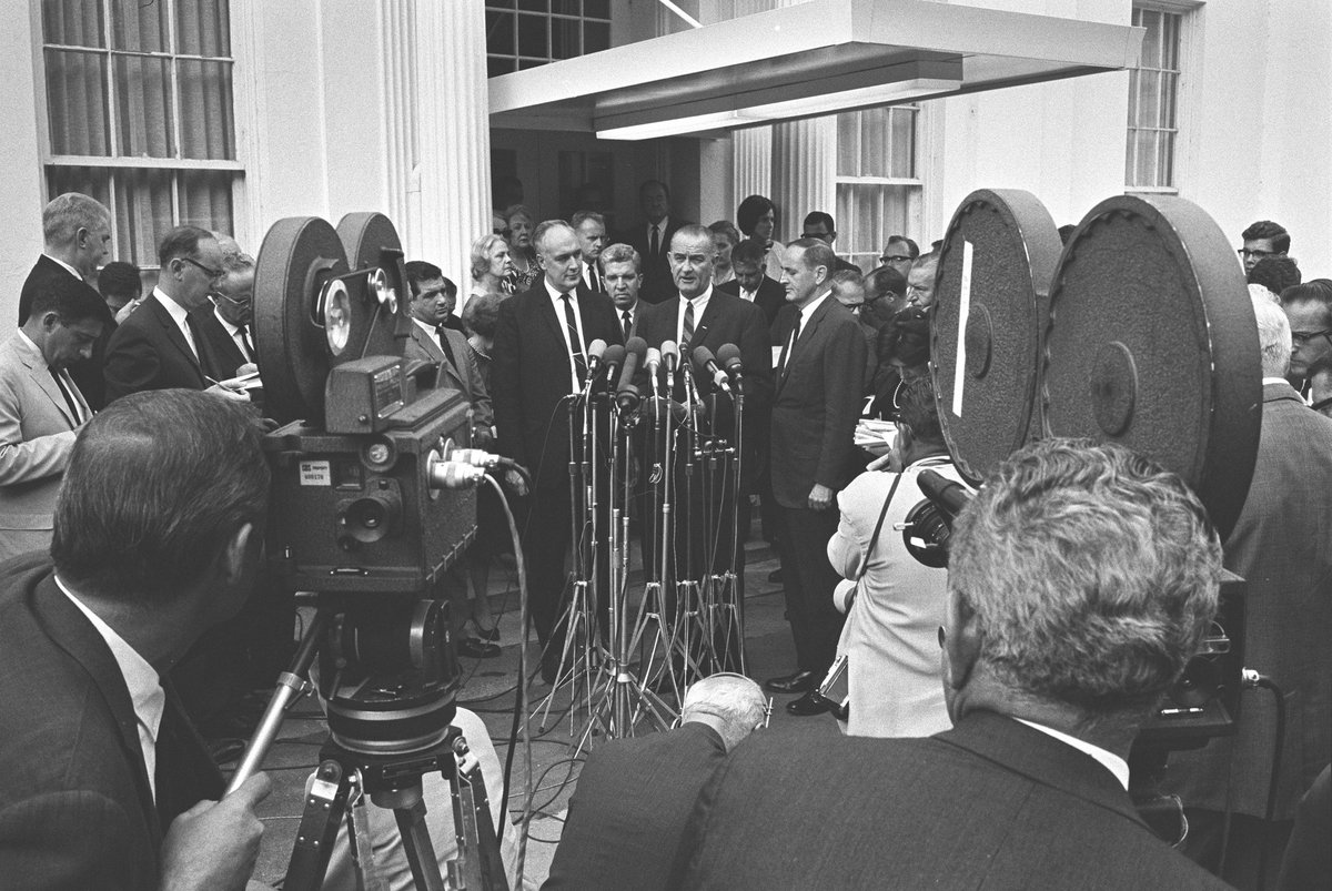 President Johnson speaking with reporters after signing Executive Order 11246. 
