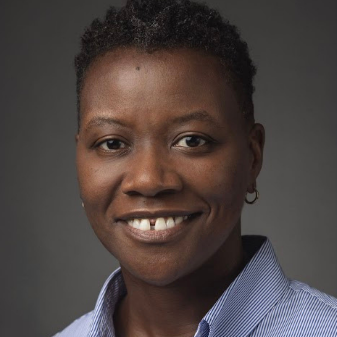 Headshot of Tamaya Dennard smiling, wearing a striped button-down shirt against a dark background.