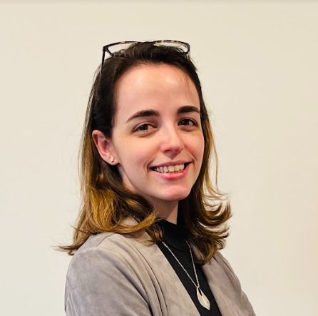 Headshot of Courtney Lamendola smiling, wearing glasses and a light blouse.