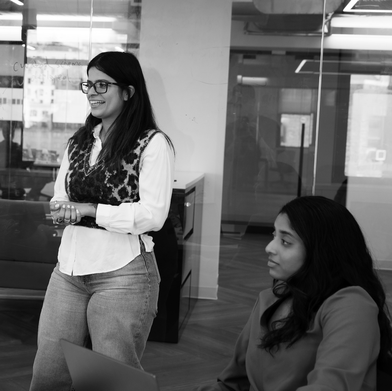 Two Translucent team members in conversation next to a whiteboard