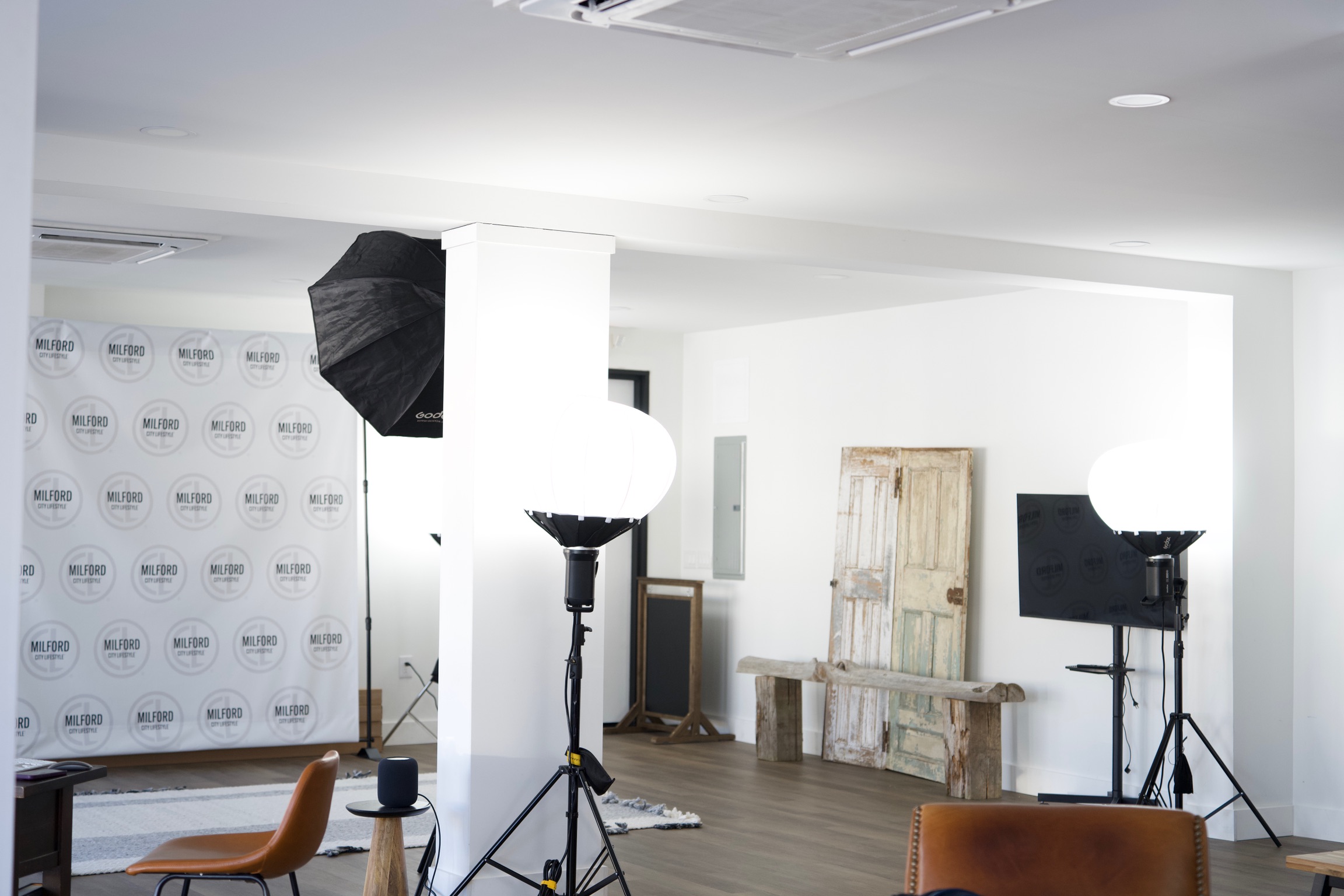 a creative studio space in downtown Milford with computers, TVs, chairs, tables, photo equipment, etc.