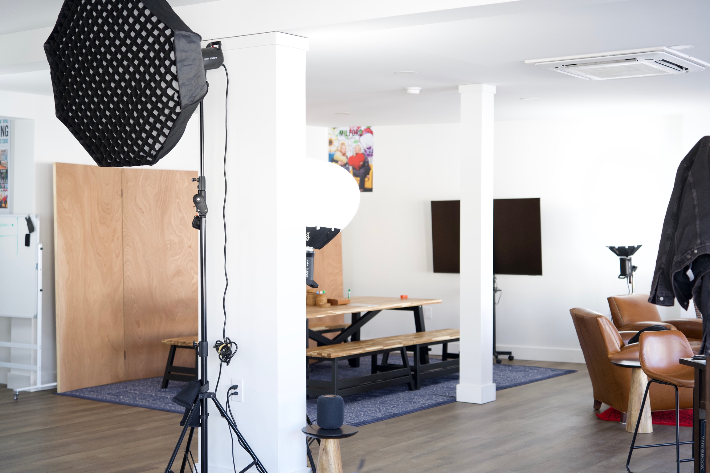 a creative studio space in downtown Milford with computers, TVs, chairs, tables, photo equipment, etc.