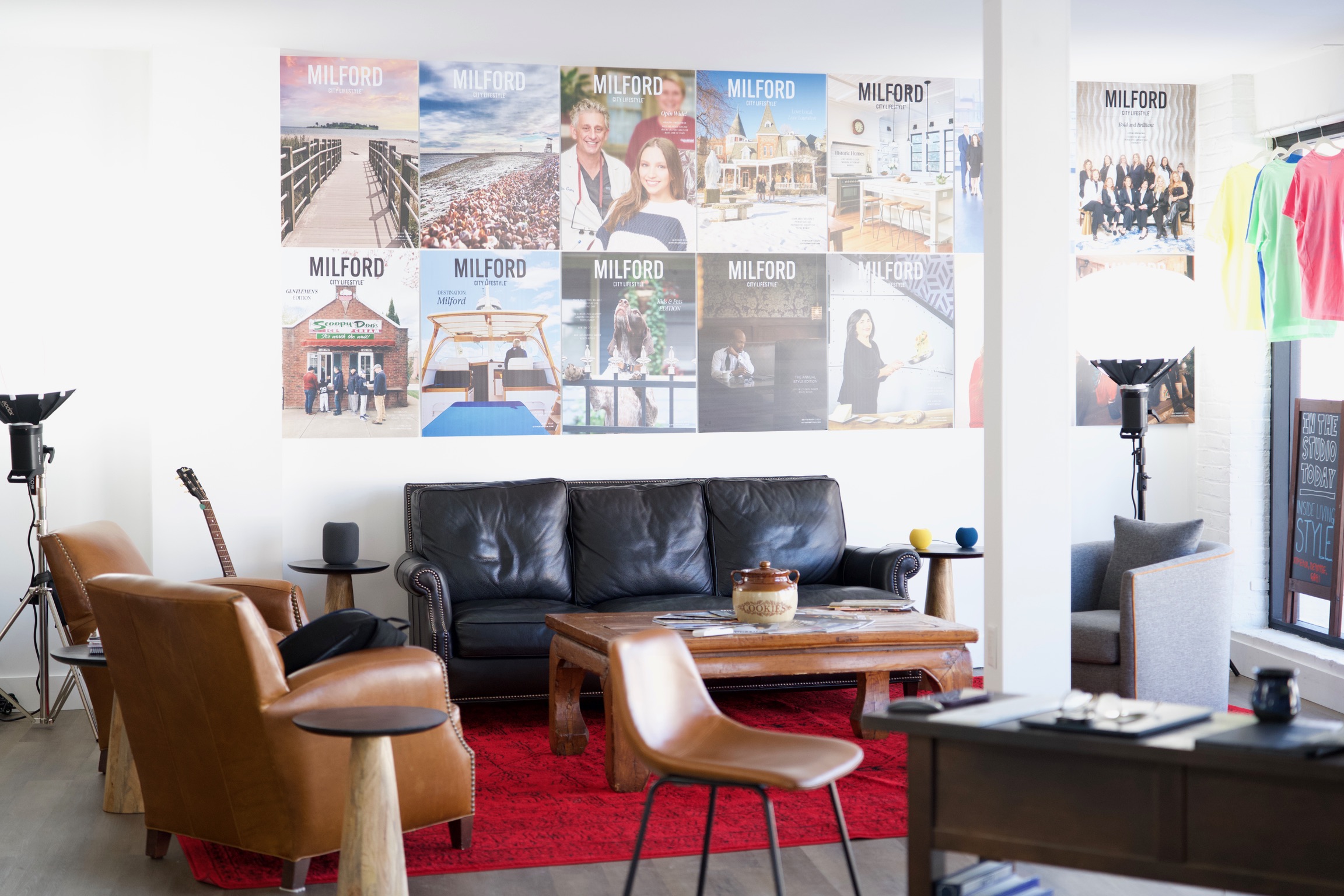 a creative studio space in downtown Milford with computers, TVs, chairs, tables, photo equipment, etc.