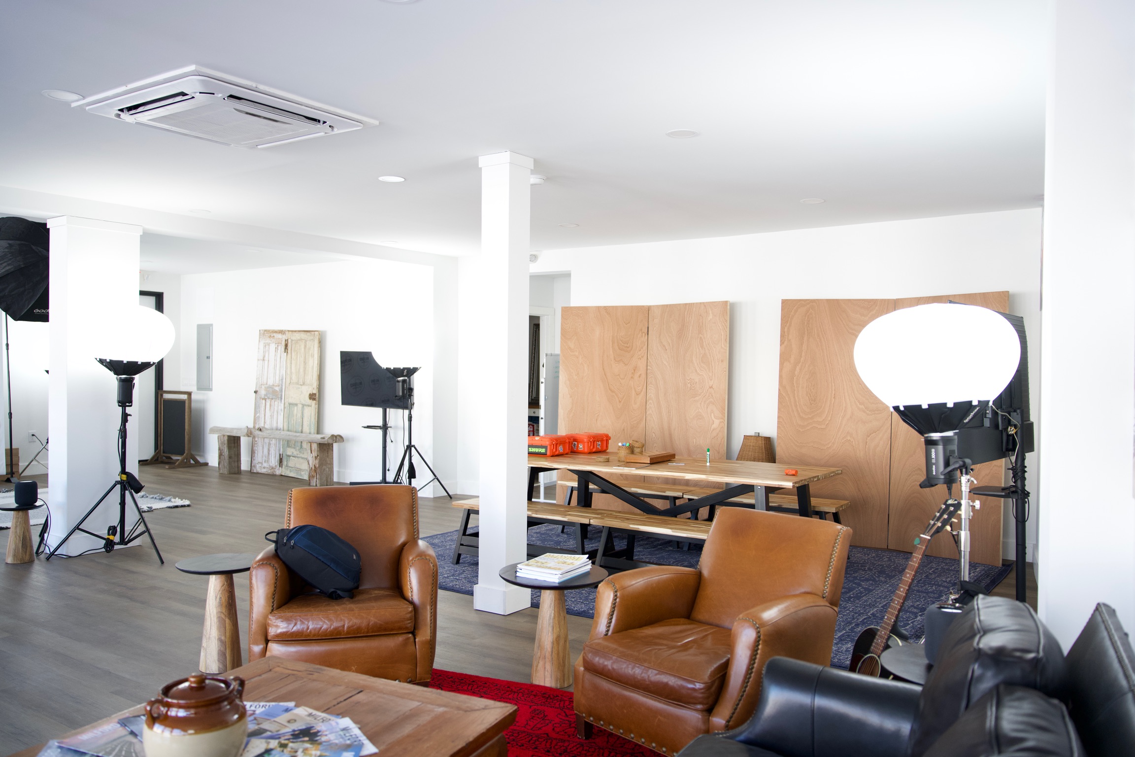 a creative studio space in downtown Milford with computers, TVs, chairs, tables, photo equipment, etc.