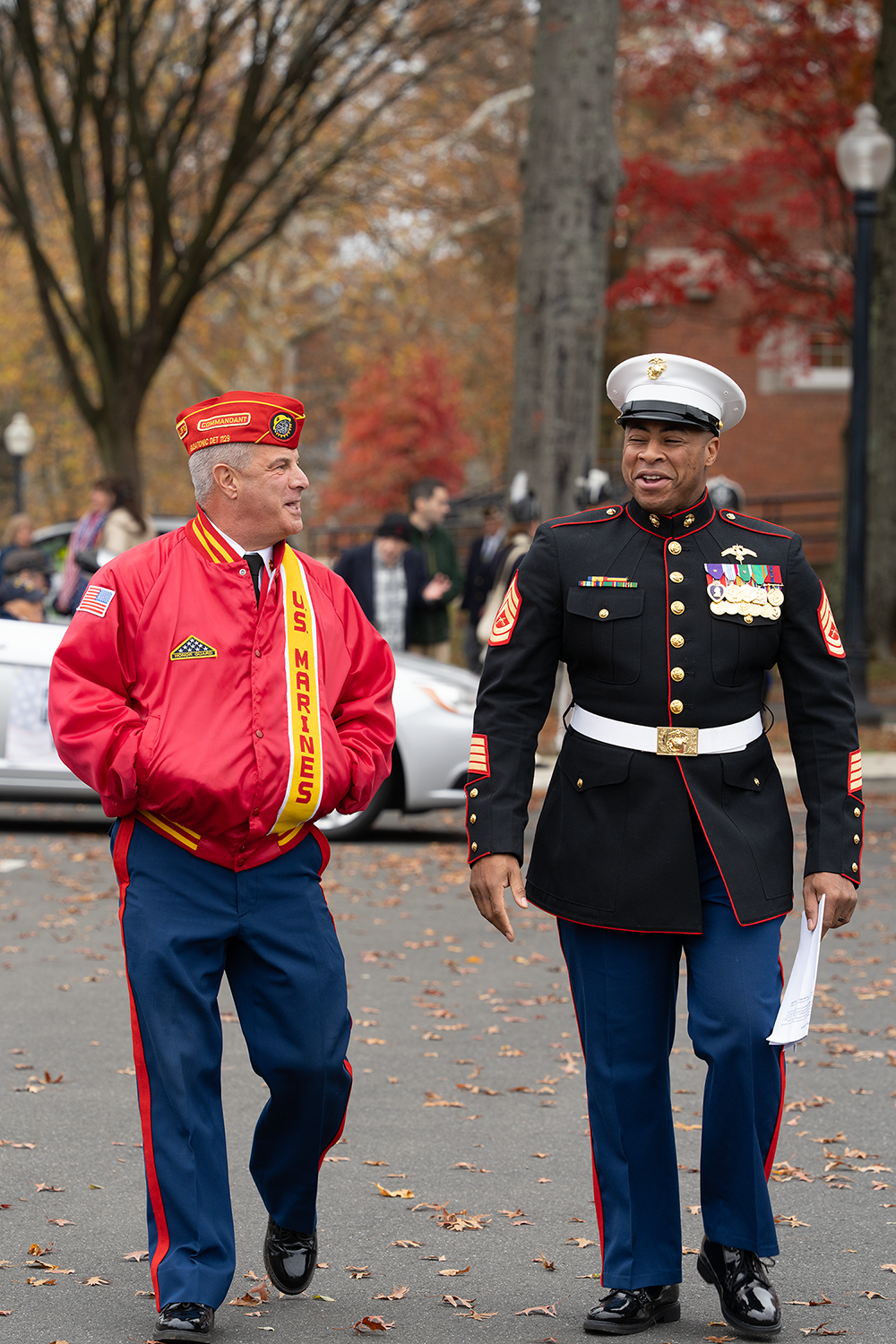two decorated veterans walking on a road