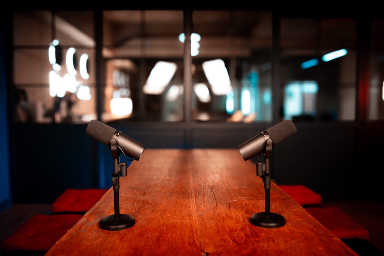Wooden recording table with two microphones in a Poddworx studio