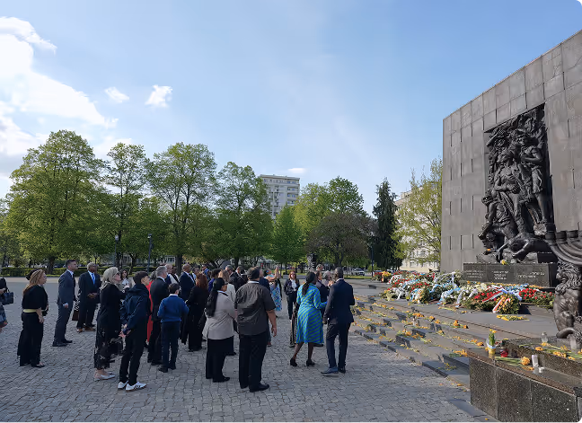 photo of delegation standing in front of a Jewish memorial