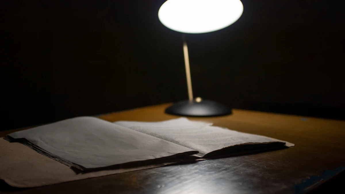 Open leather notebook on a wood desk illuminated by a warm lamp, representing late-night commission reconciliation