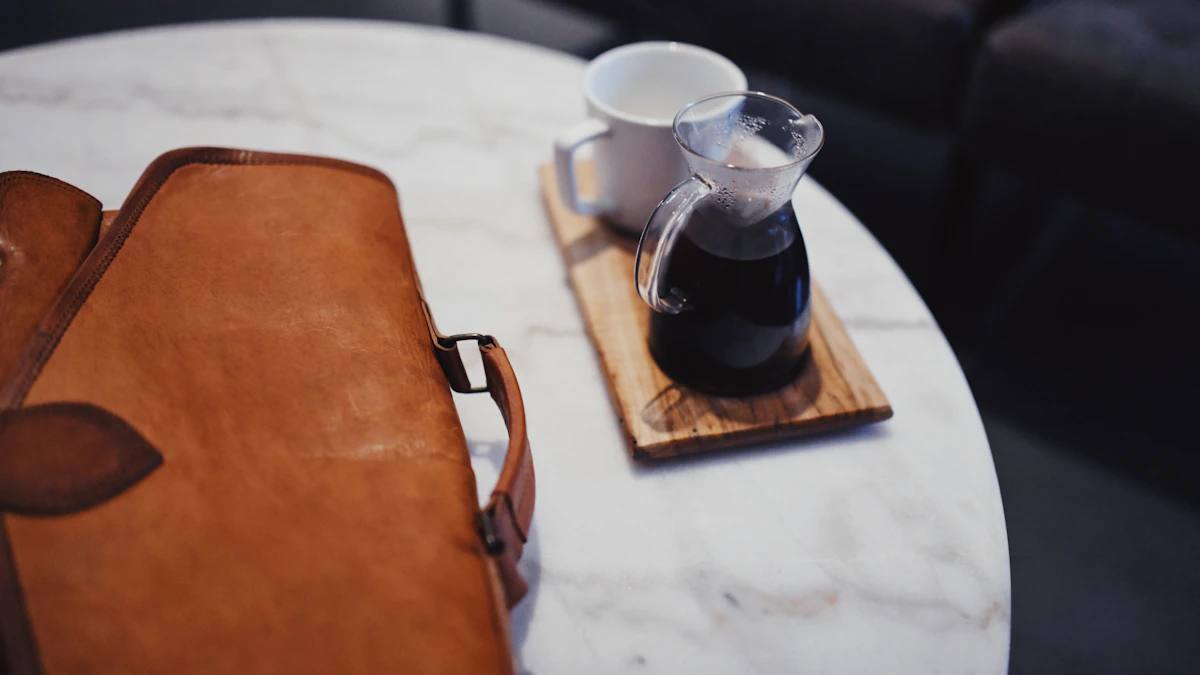 Open linen-covered notebook beside a steaming coffee cup on a wooden desk