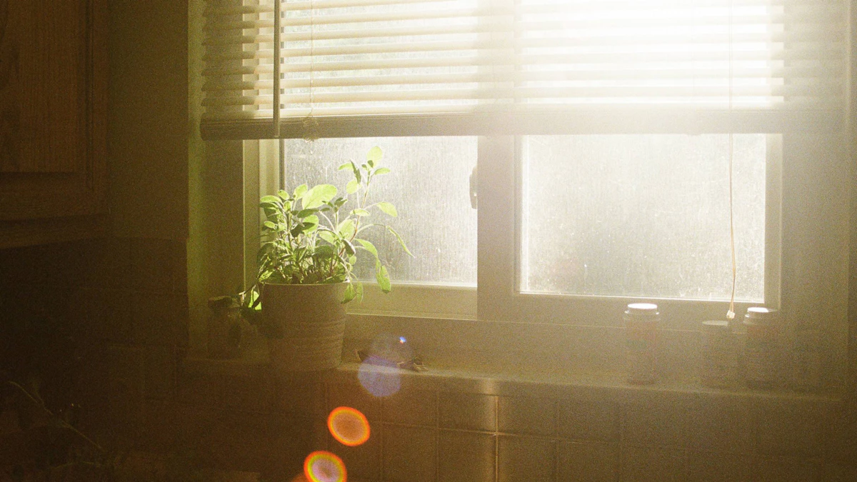 Open laptop on a clean desk beside a window with soft morning light