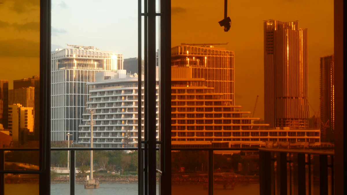 Glass-walled office interior at golden hour with a city skyline visible through floor-to-ceiling windows