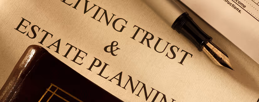 Close-up of a document titled 'Living Trust & Estate Planning' with a fountain pen resting on it near the top right corner.