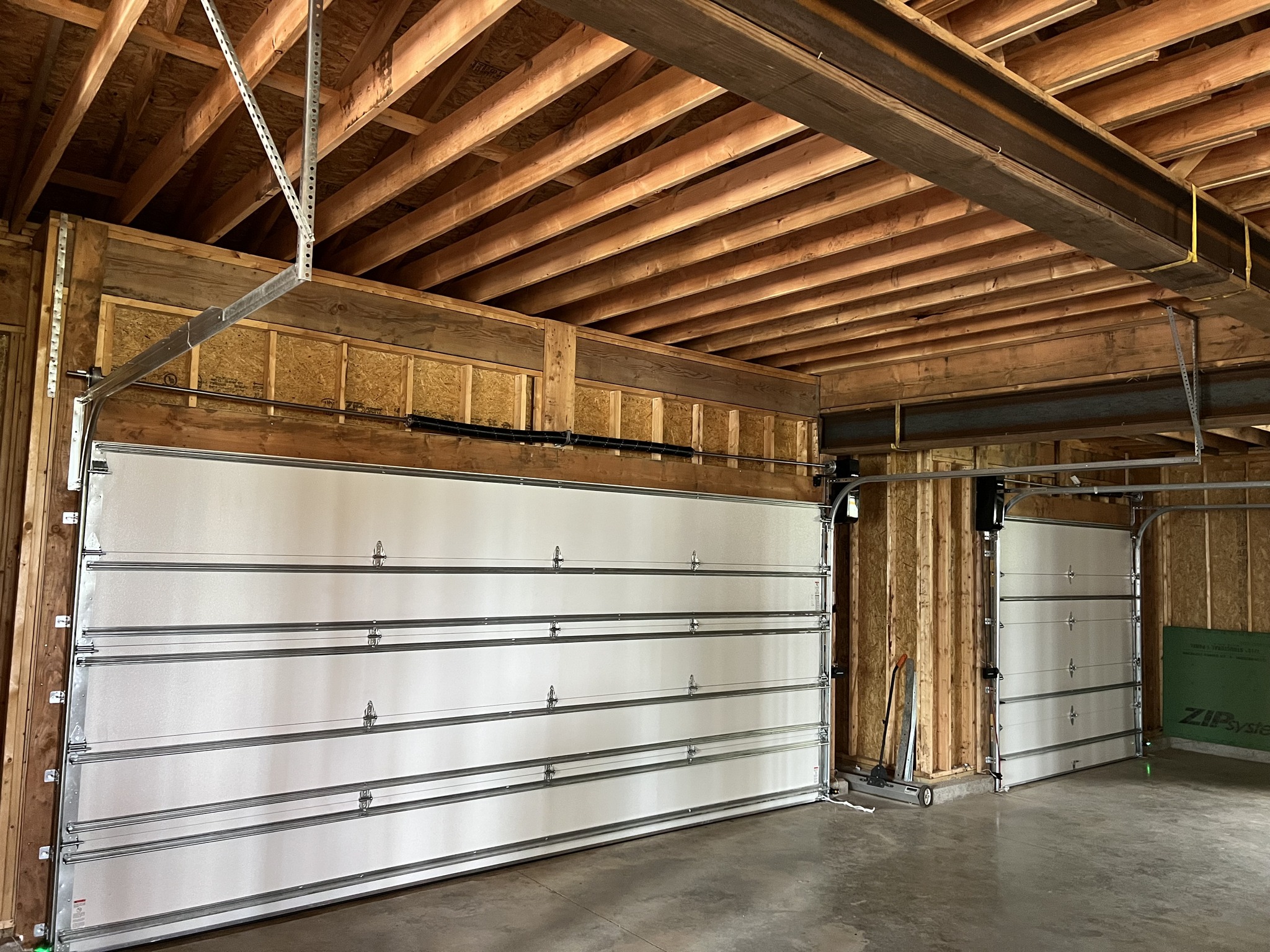 Interior view of two newly installed DoorLink 3700 garage doors with maximum wind load support struts.