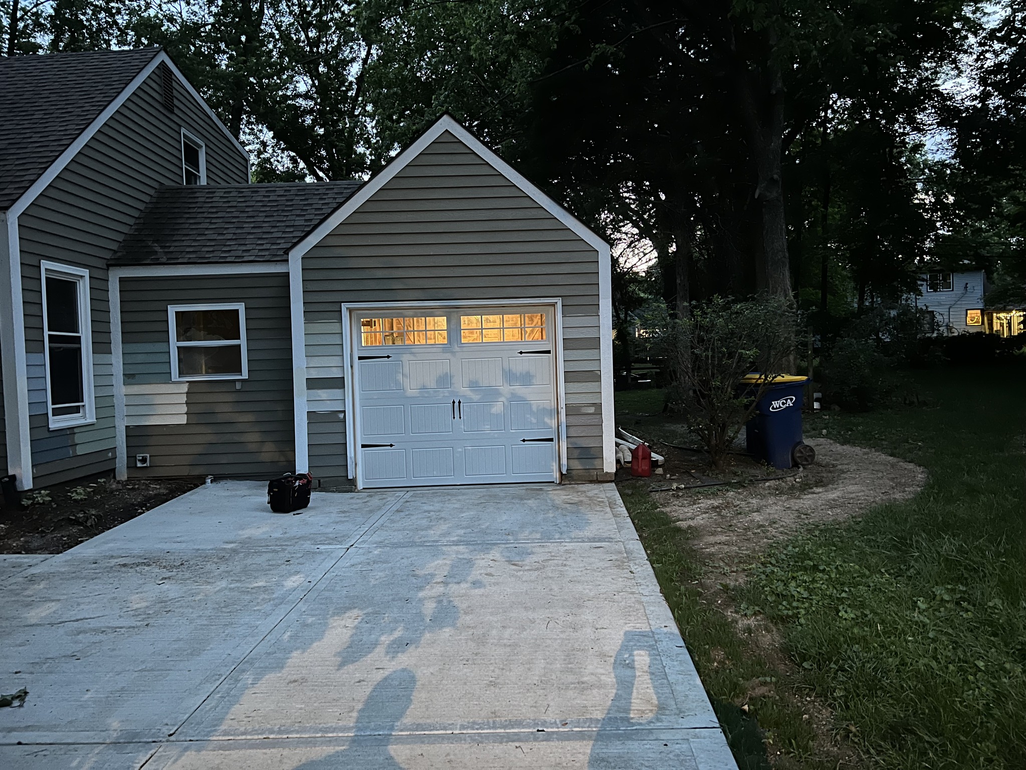 Garage Exterior showing a newly installed DoorLink 3630 in white with long panel glass and Stockton inserts with deco hardware applied.