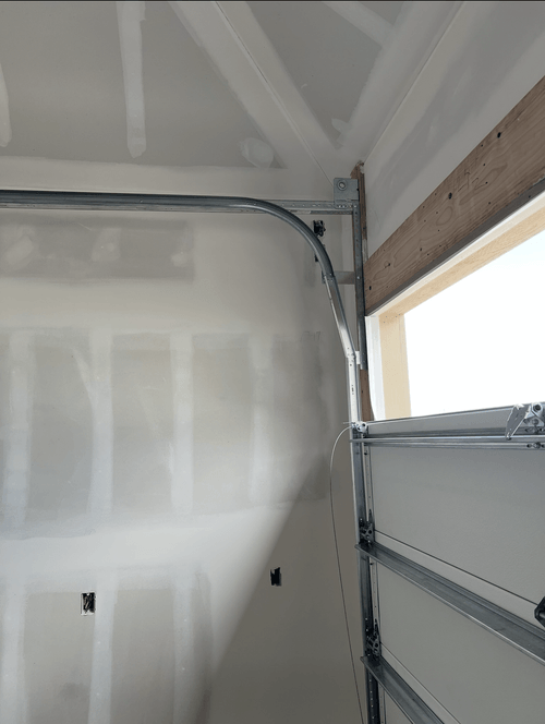 Four Layer garage door, mid install, showing high lift track.