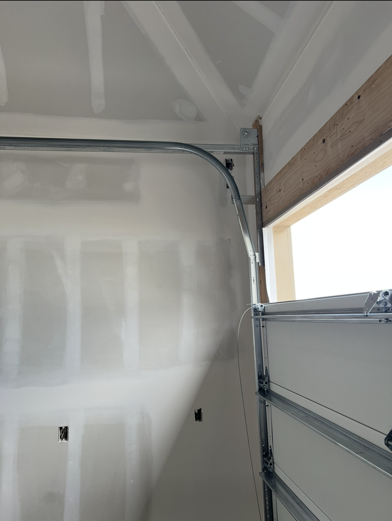 Four Layer garage door, mid install, showing high lift track.