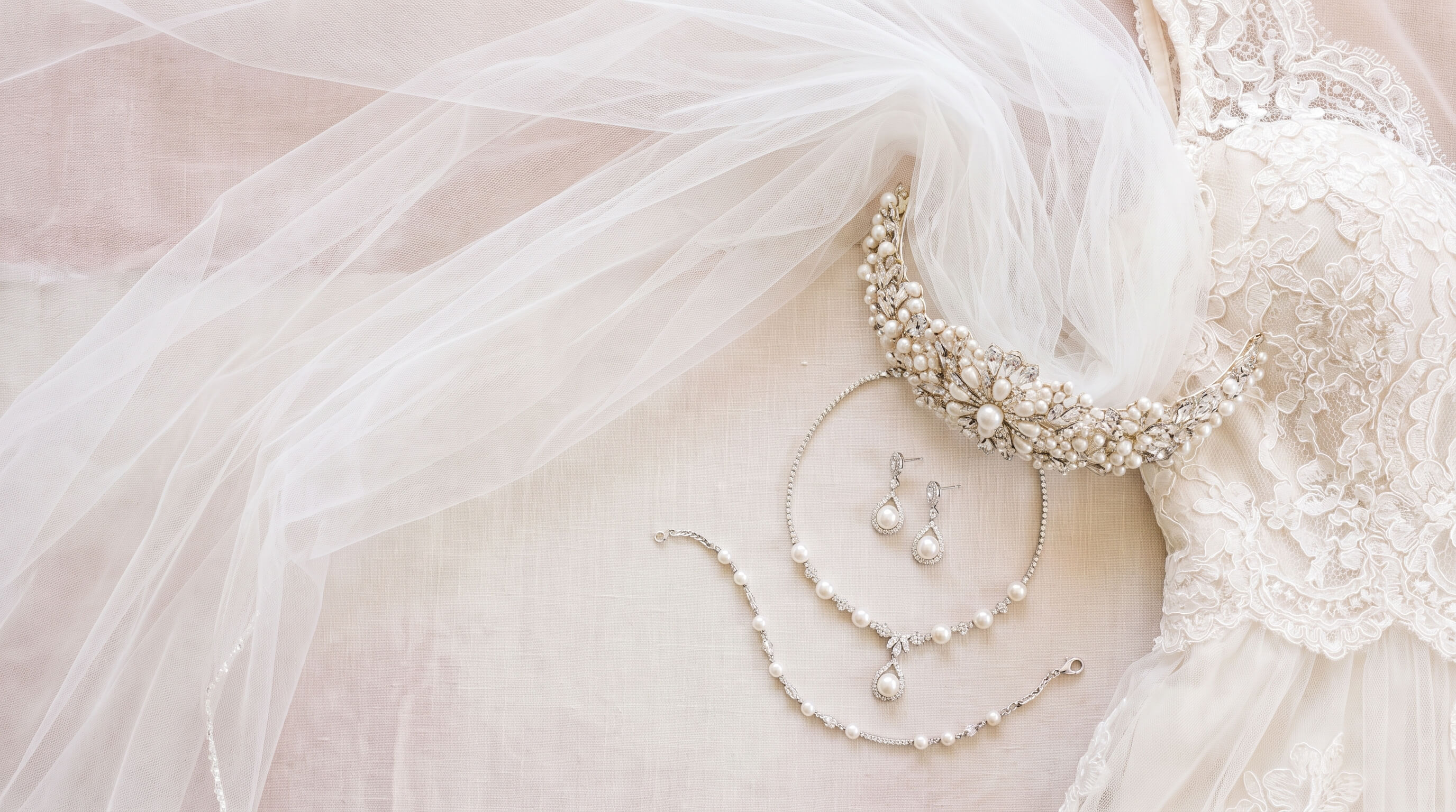 A bride wearing a satin bridal gown and holding a flower bouquet
