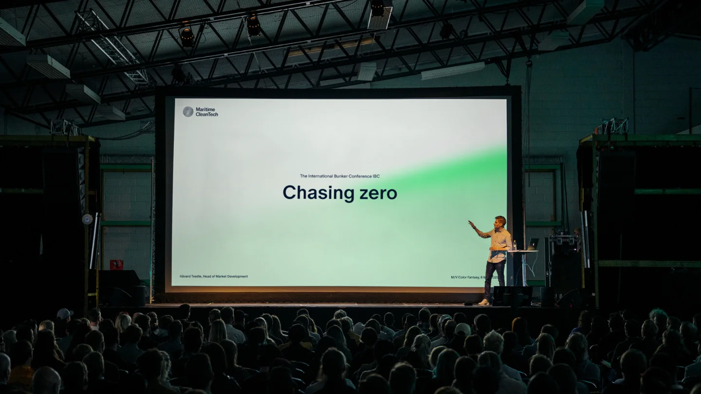 Speaker on stage presenting 'Chasing zero' at The International Bunker Conference to a large audience.