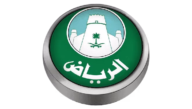 Circular emblem featuring a white fortress with a palm tree and crossed swords on a green background, with Arabic text below.