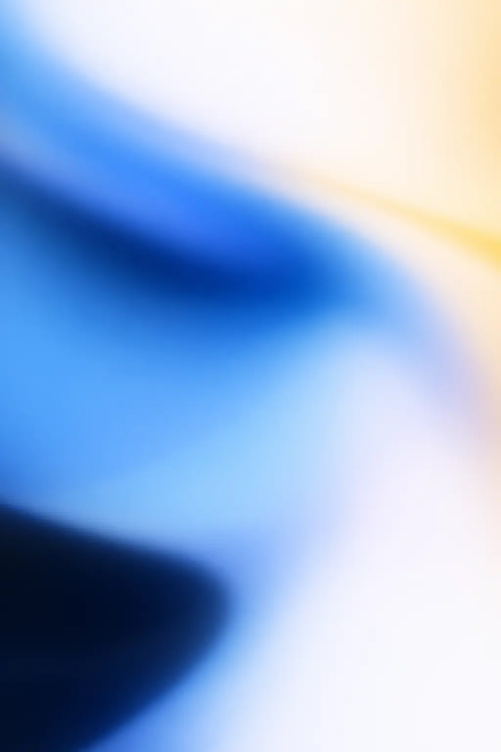 Abstract blurred gradient with shades of blue, white, and soft yellow.