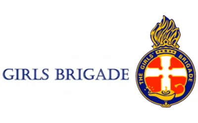 Girls Brigade logo featuring a gold flame above a blue and red badge with a white cross and a lamp.