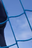 Close-up of a blue net against a blue sky background.