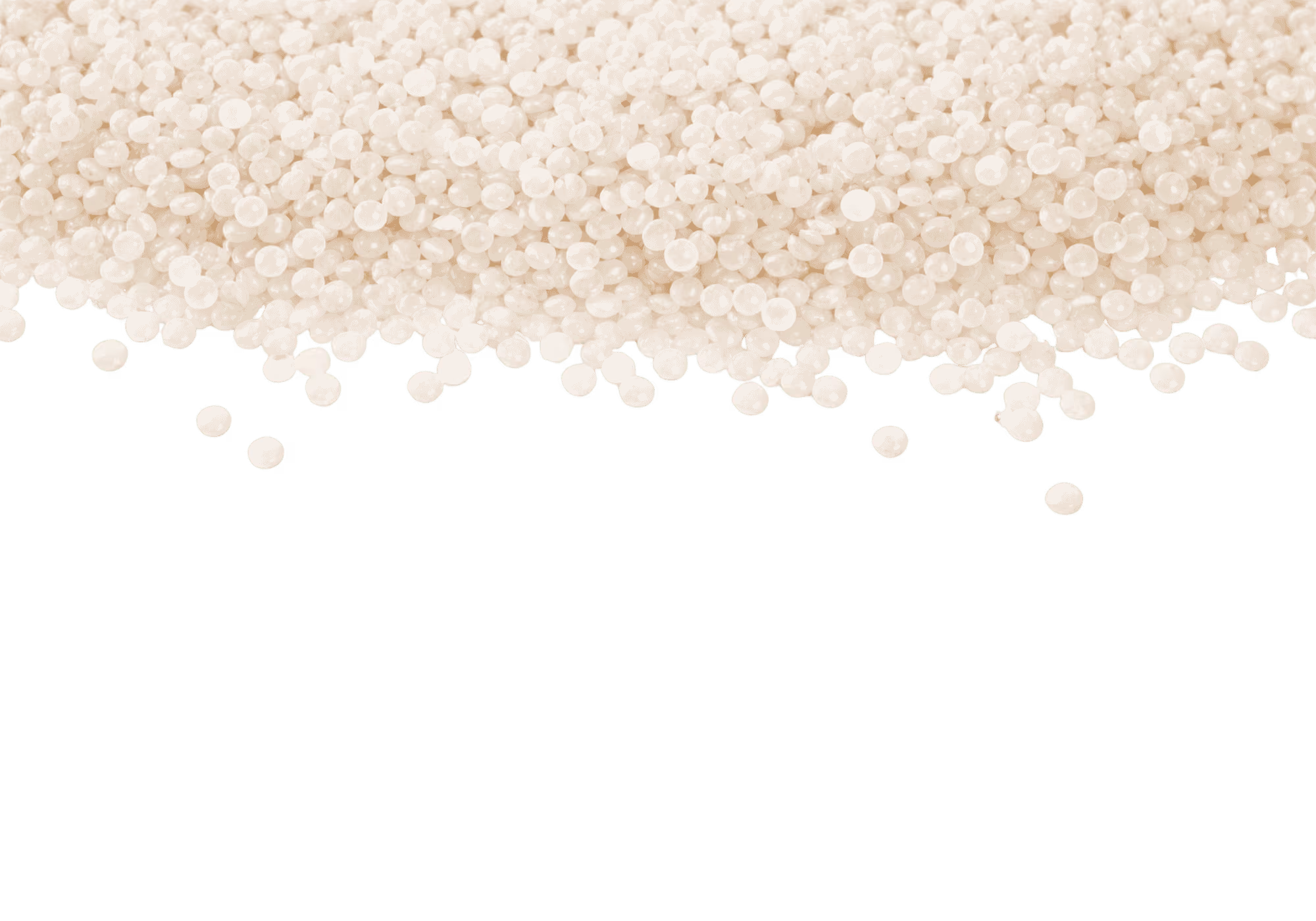 Close-up of many small translucent white plastic pellets scattered on a surface.