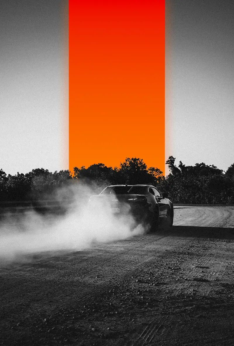 Car drifting on a dirt road, kicking up dust with trees and a vertical orange gradient in the background.