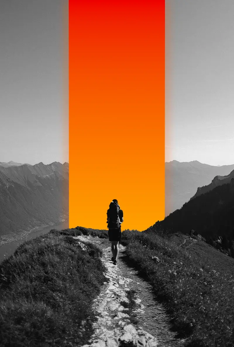 Hiker with a backpack walking along a mountain path illuminated by a vertical gradient orange light strip, surrounded by grayscale mountains.