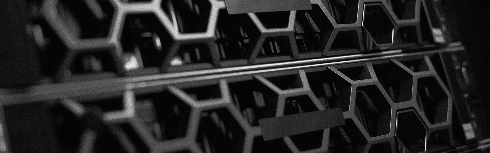 Close-up of black hexagonal patterned ventilation grille on server hardware.