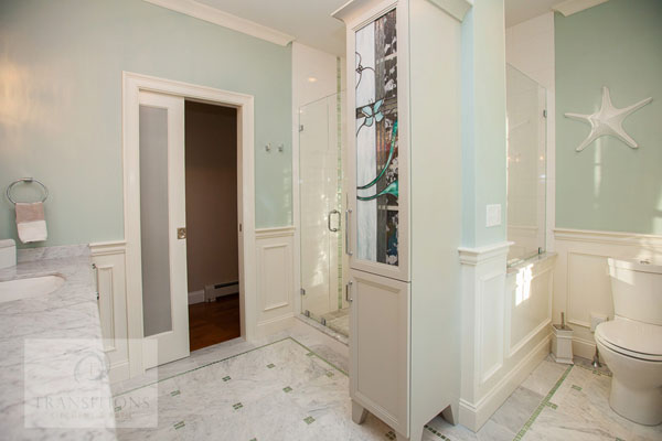 Coastal modern Scituate primary bathroom with Bianco Carrera marble floor and glassblend mosaic details
