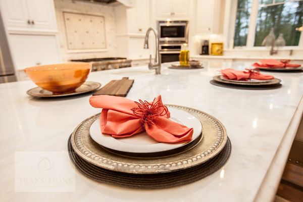Traditional Norwell kitchen with white painted cabinetry, Calacatta marble countertops, and a large island