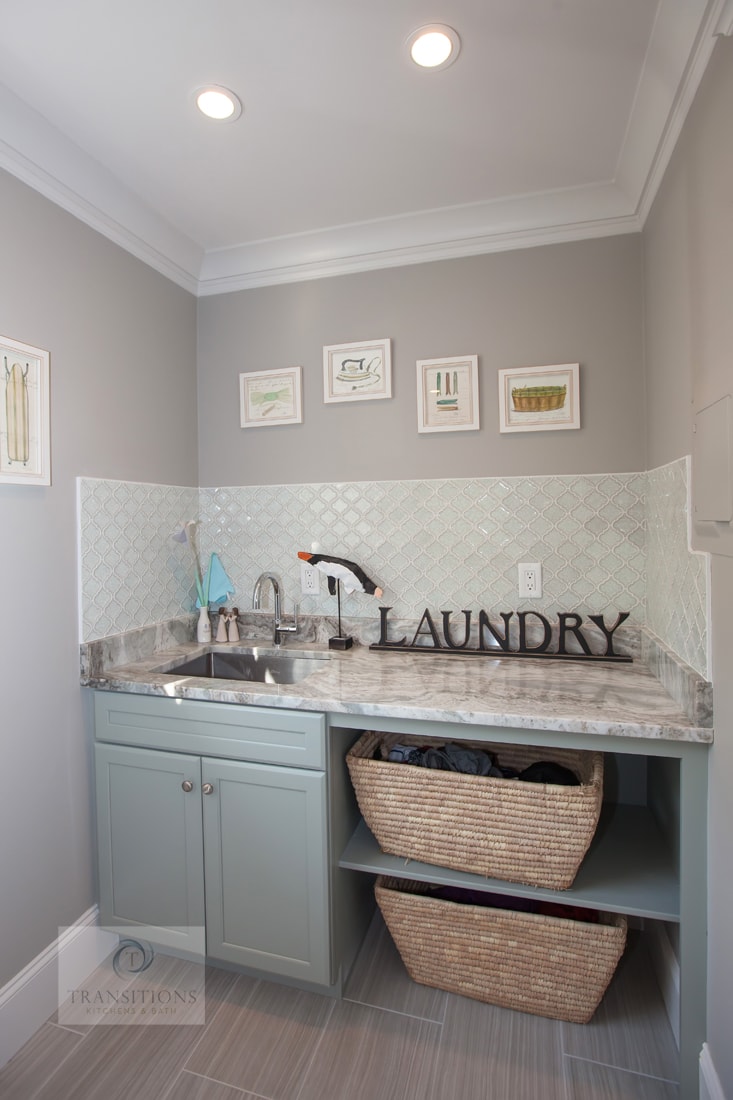 Traditional Norwell laundry room with side-by-side washer and dryer, countertop workspace, and built-in storage