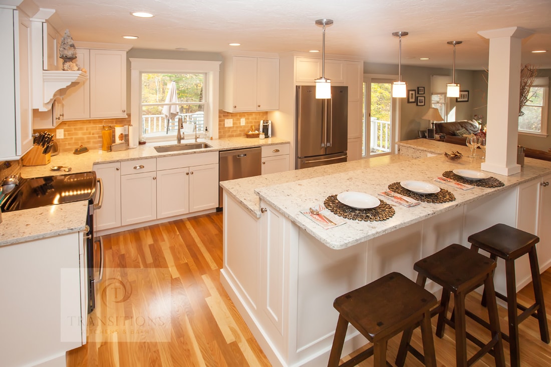 Cohasset kitchen with a bi-level island, built-in wine rack, and integrated storage throughout