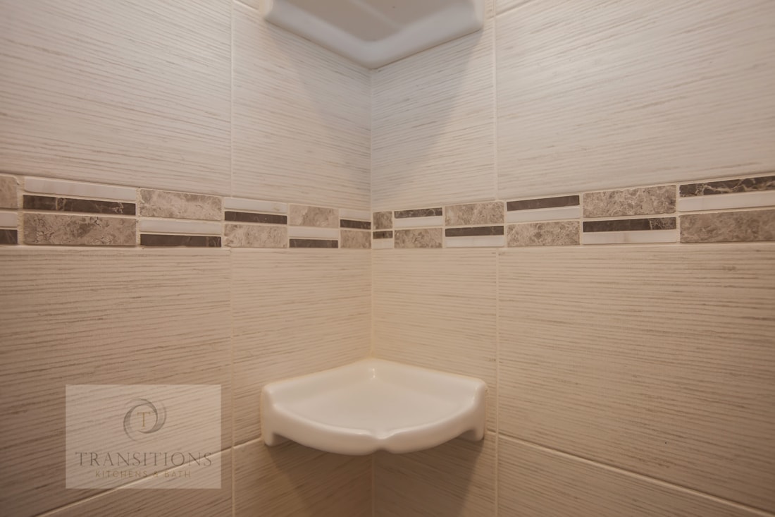 Walk-in shower with basket weave floor tile in the Hingham guest bath