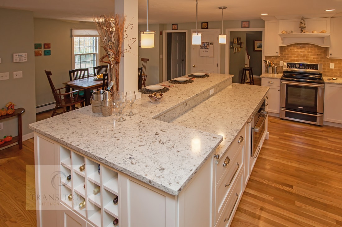 Bi-level island with working surface and casual dining counter in the Cohasset kitchen