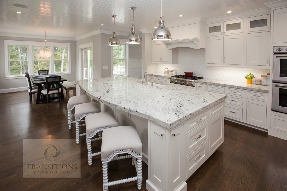 Norwell kitchen remodel with a large island, seating, and undercounter microwave by Transitions