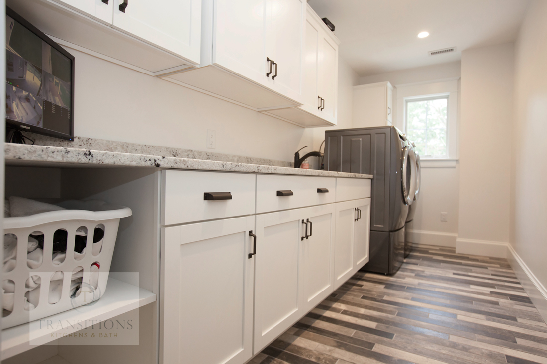Norwell laundry room with side-by-side washer and dryer, Masterbrand Diamond Vibe cabinets, and open shelving