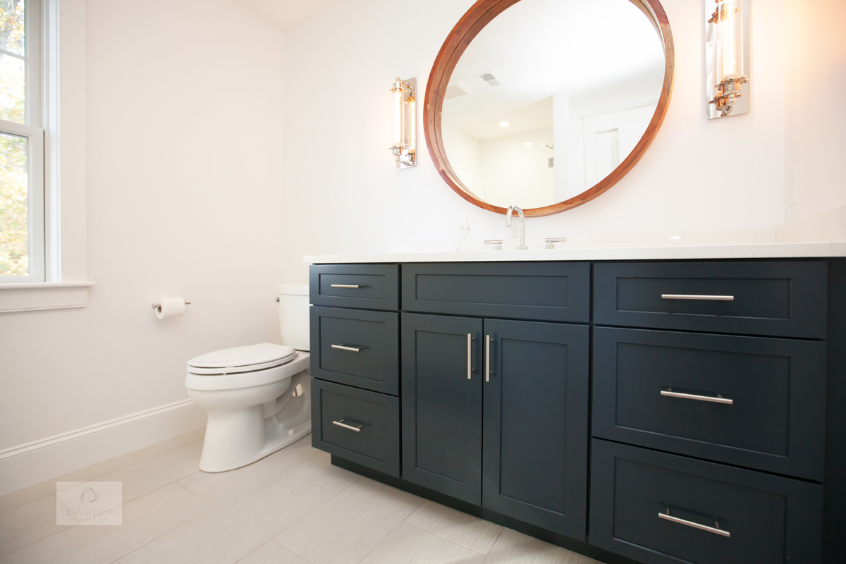 Traditional Norwell kids' bathroom with a Diamond blue vanity, round wood-framed mirror, and brushed nickel hardware