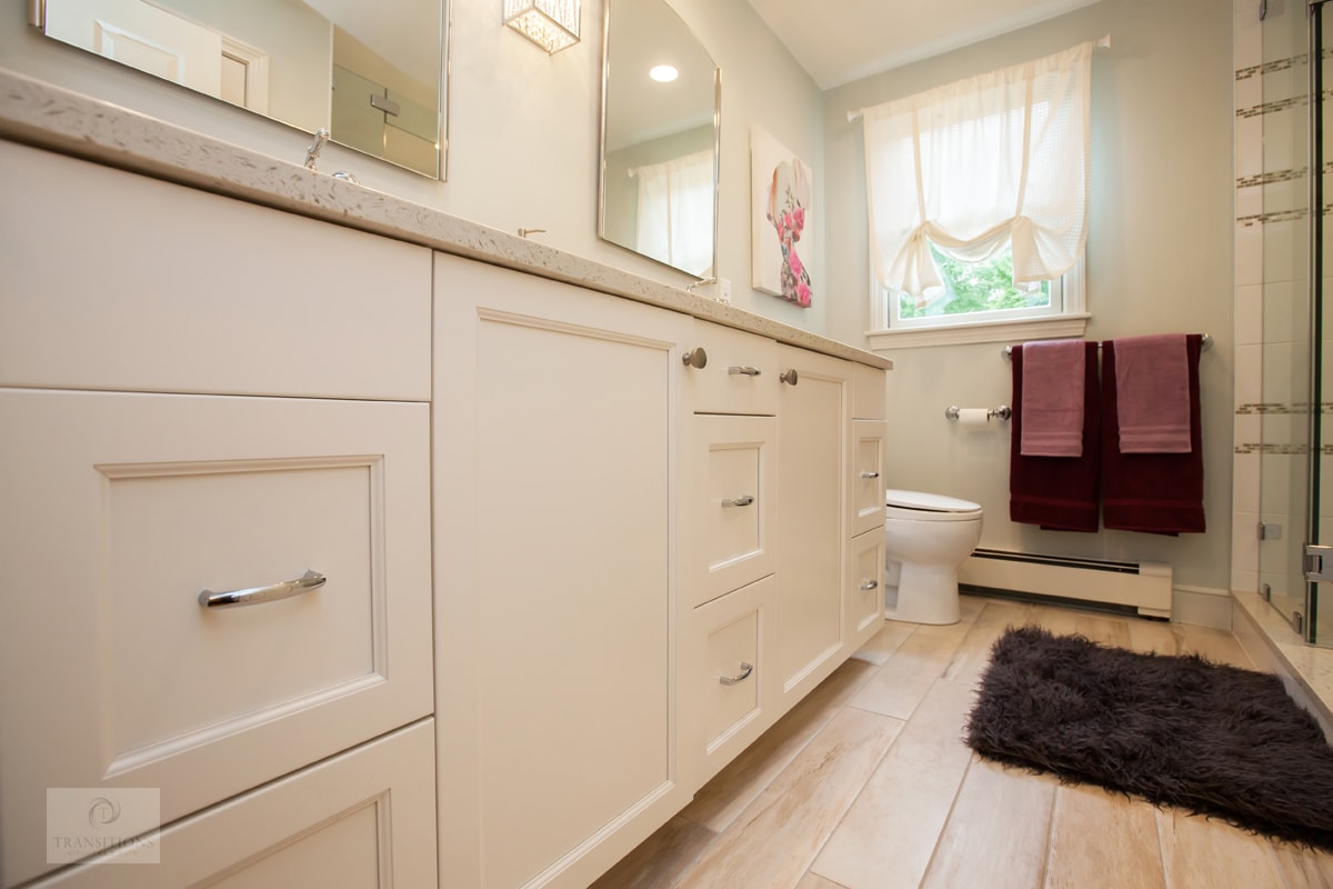 Hanover kids' hall bathroom with extra long shower, glass doors, mosaic tile floor, corner seat, and white Tedd Wood vanity