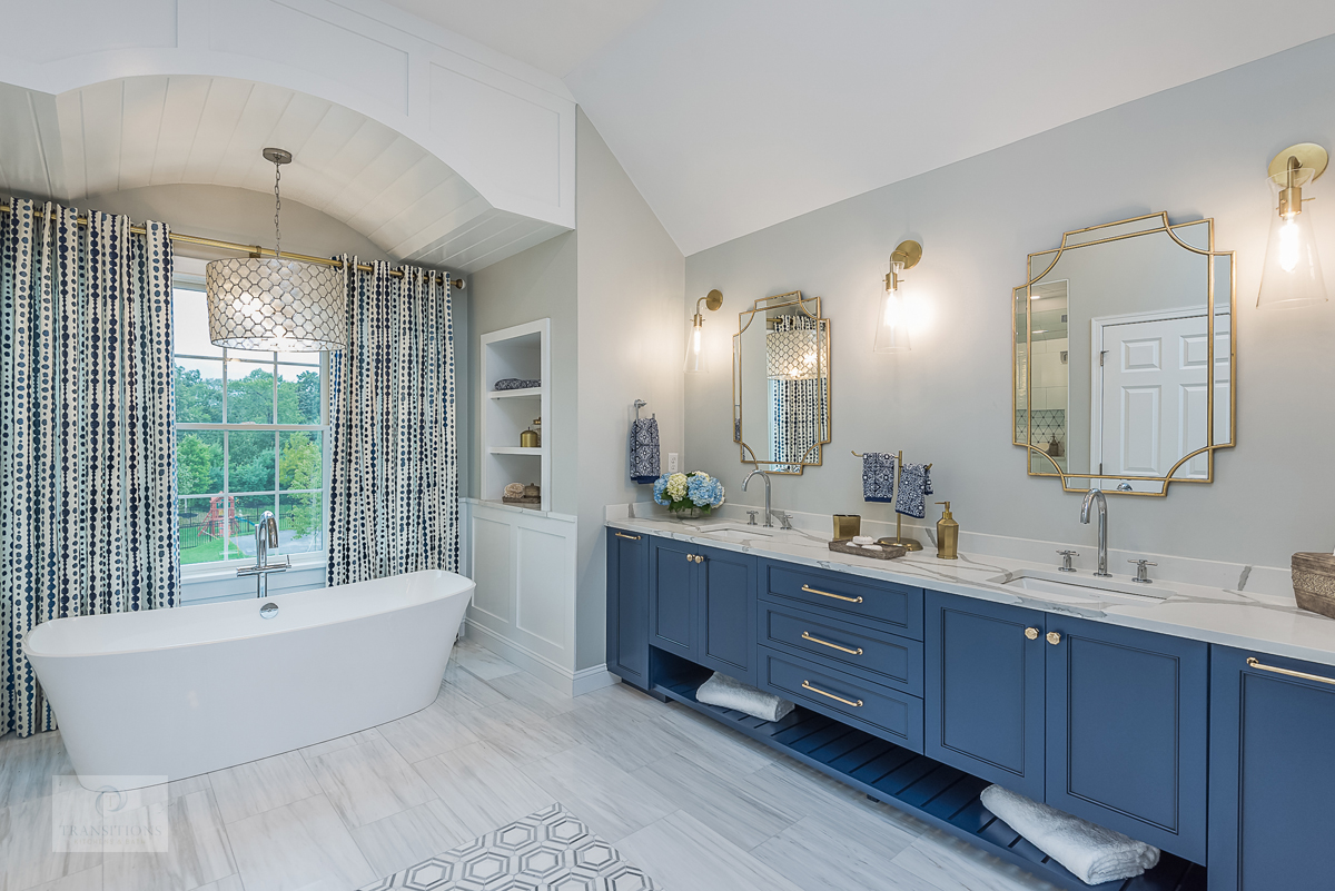 Cohasset bathroom with a vibrant blue Tedd Wood vanity, brass hardware, and Calacatta Bettogli countertop