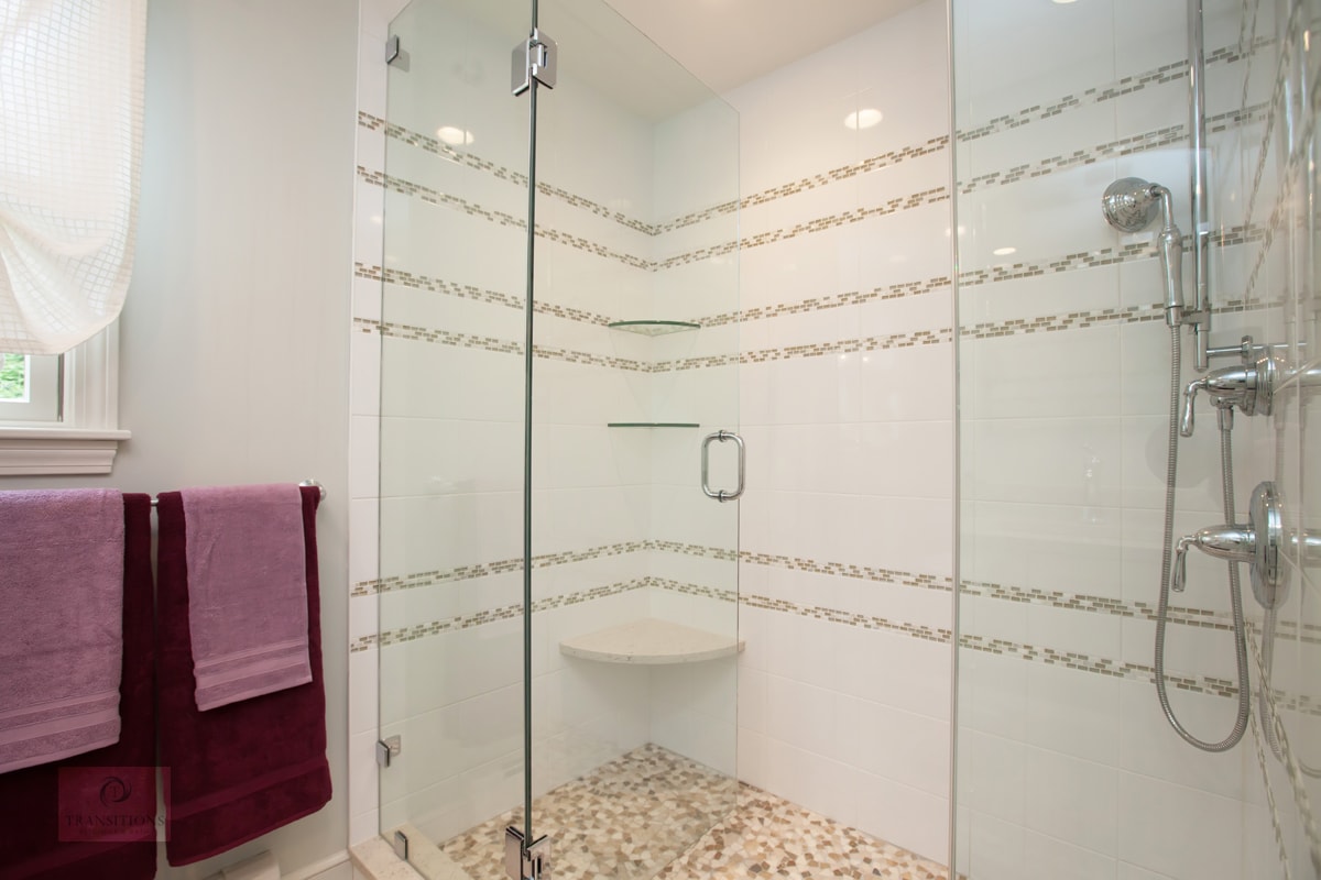 Extra-long glass-door shower with corner seat in the Hanover kids' hall bath