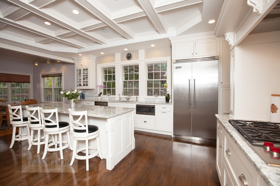 Warm wood floor tones and white cabinetry detail in the Weston kitchen