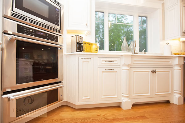 White painted cabinetry with Calacatta marble countertops in the Norwell kitchen